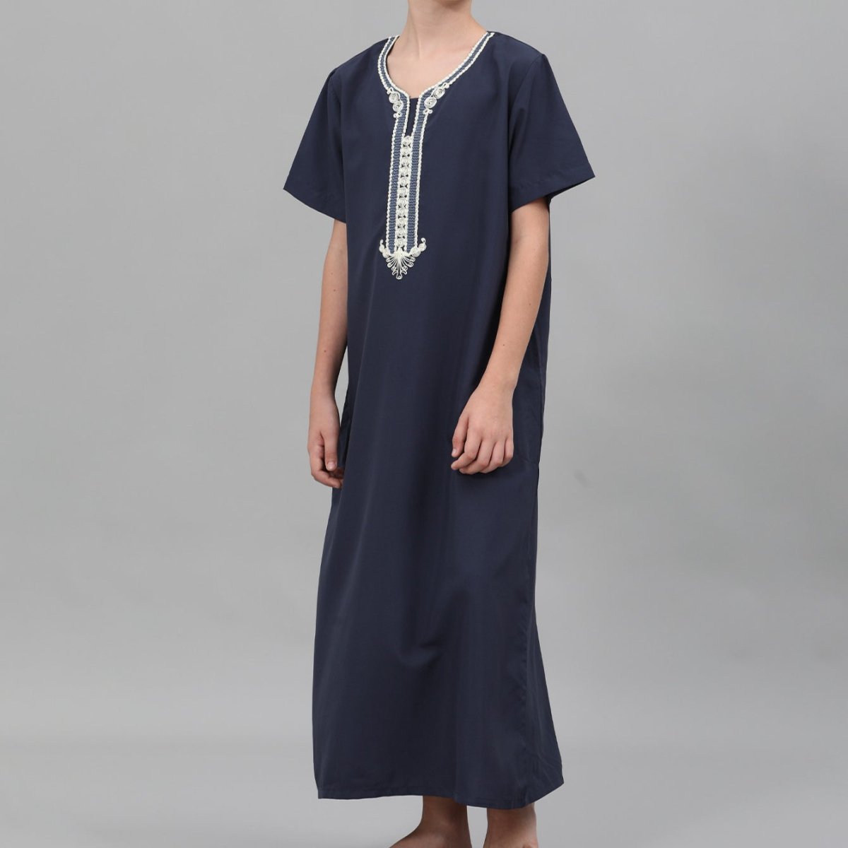White boys thobe with black and gold ornate chest embroidery