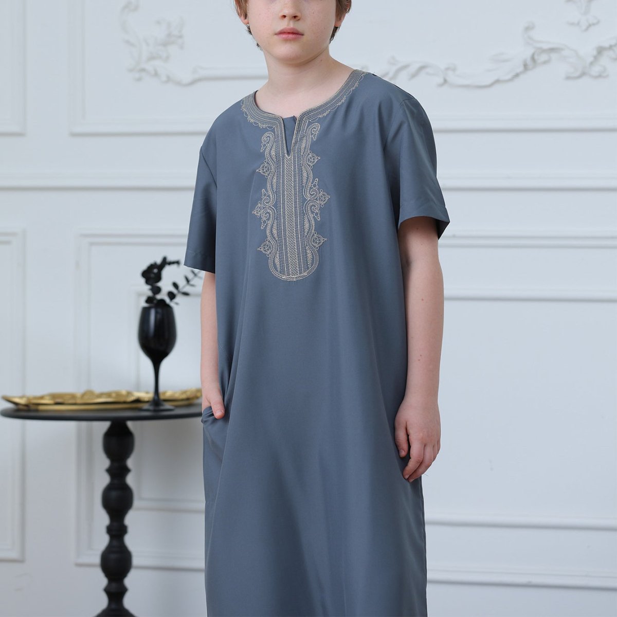 Side view showing pockets and relaxed straight-cut silhouette of boys' thobe