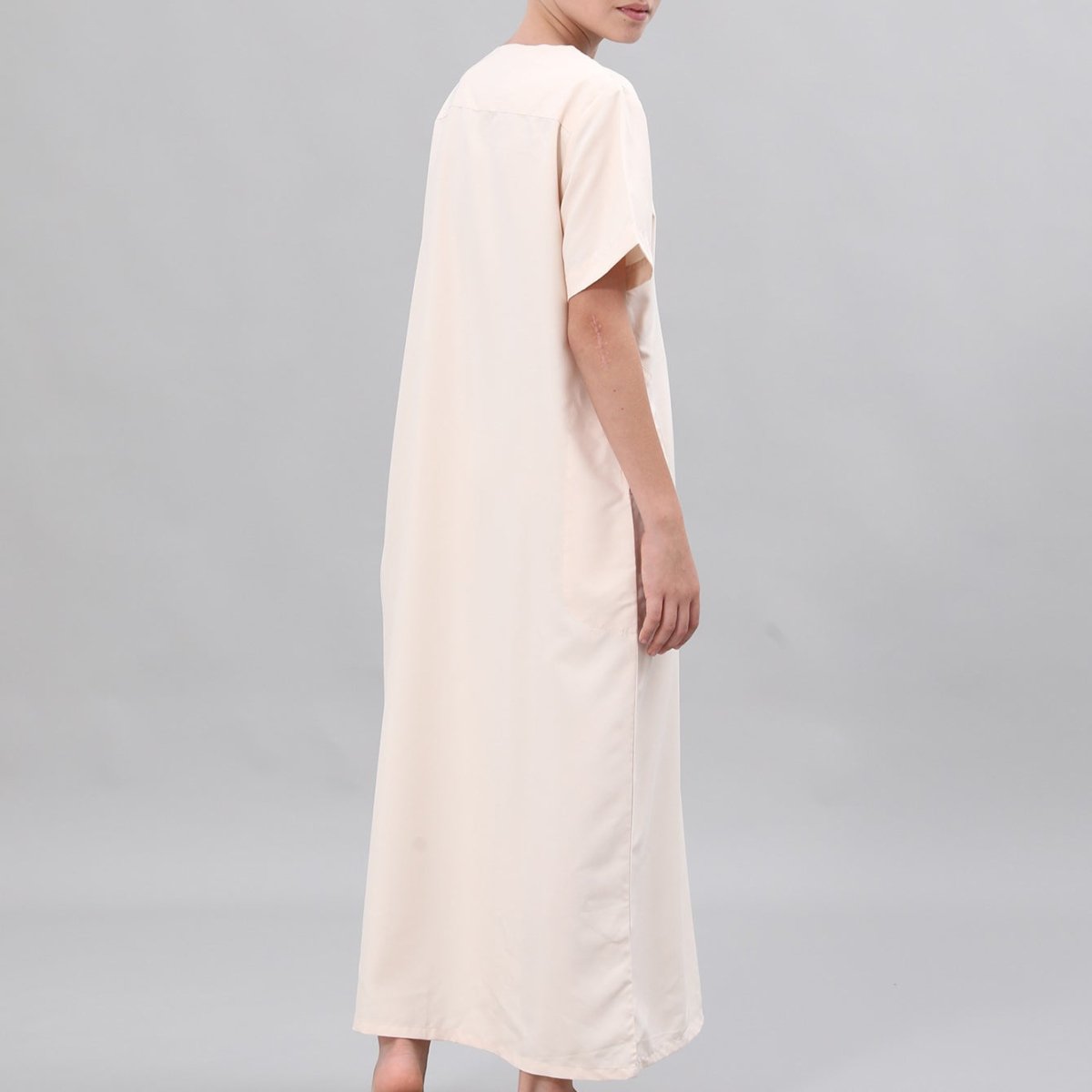 Boys' white thobe with black embroidery, side view full-length