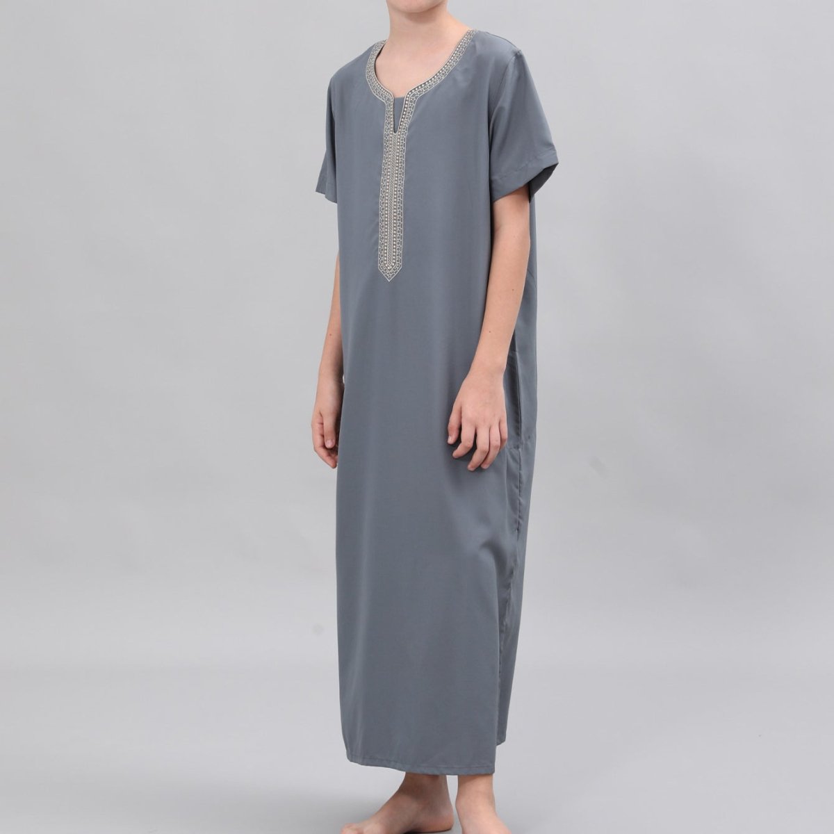 Side view of ankle-length boys' embroidered thobe showing relaxed silhouette