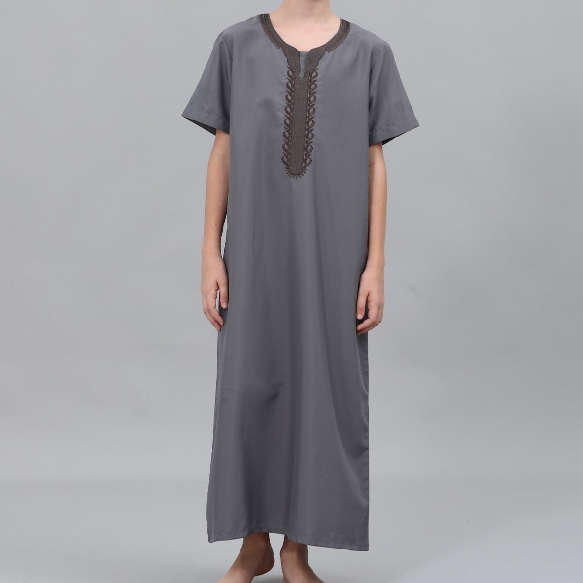 Close-up of geometric embroidery pattern on boys' thobe collar