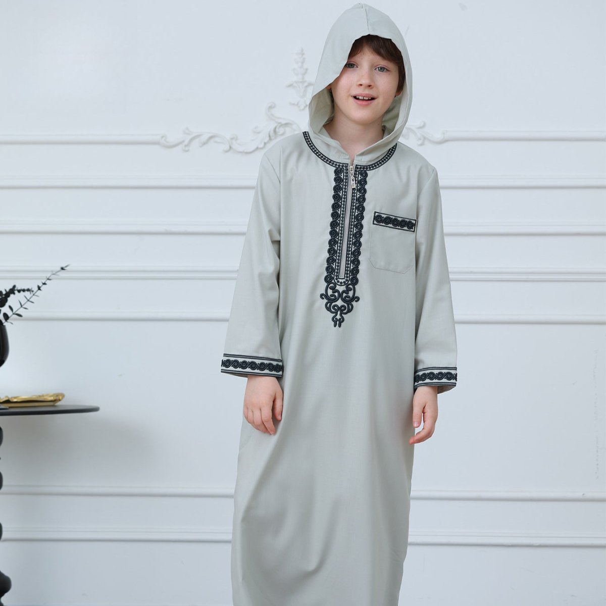 Back view of boys' hooded embroidered thobe in sage gray poly-cotton blend