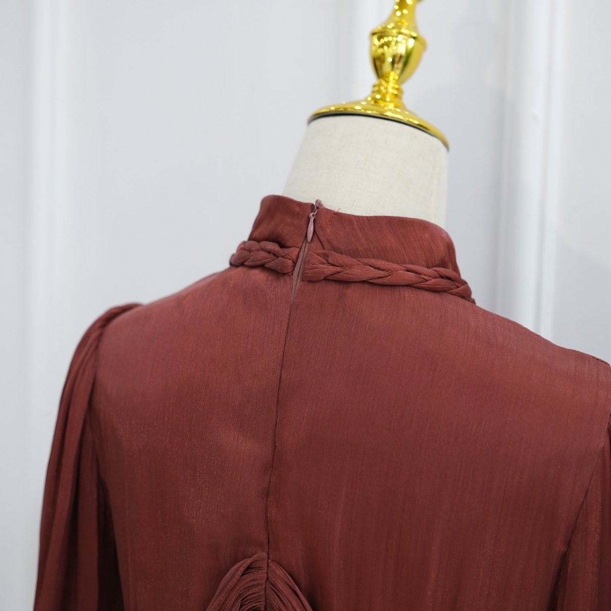Top-down detail of artisanal twisted braid neckline