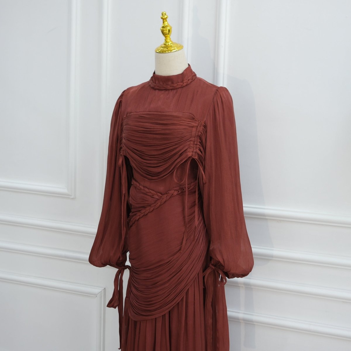 Full-length view of floor-sweeping pleated skirt in motion