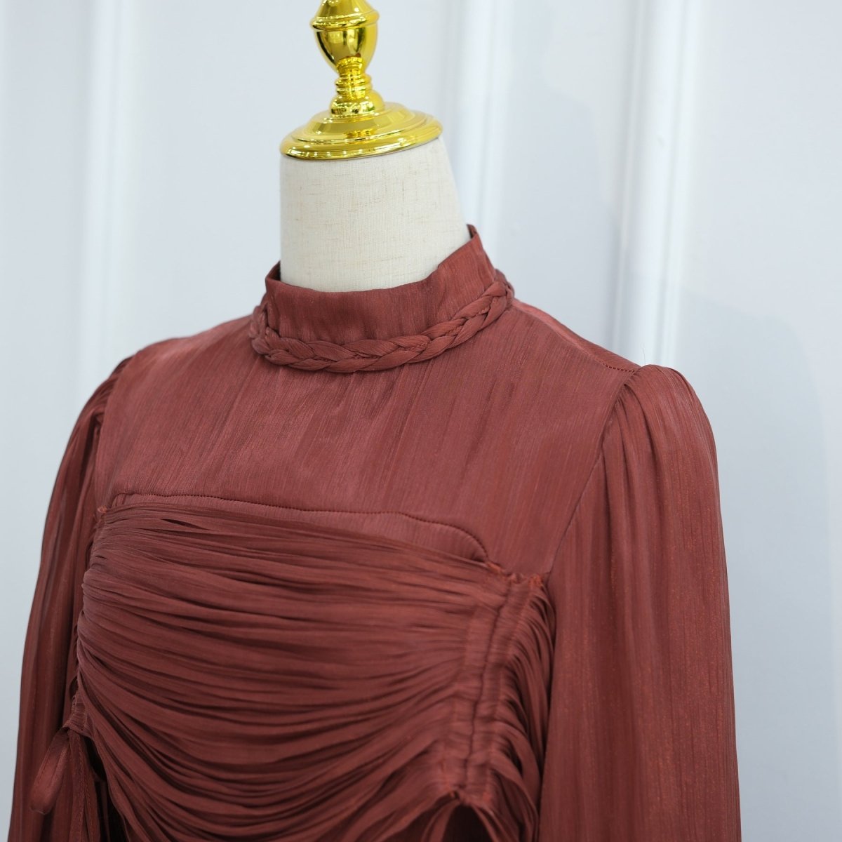 Detail of layered ruched fabric strips across the bodice