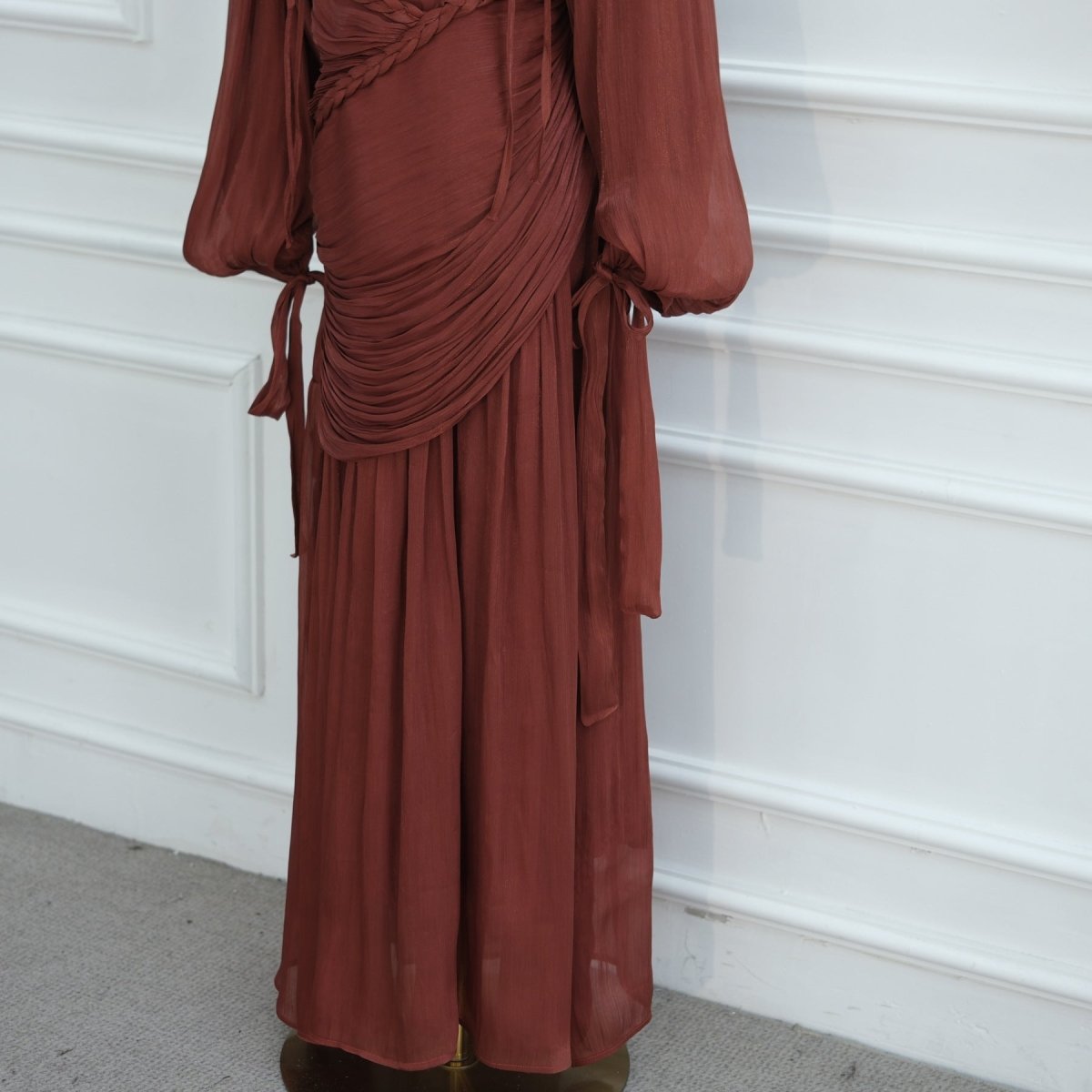 Three-quarter pose highlighting braided collar and bodice drama
