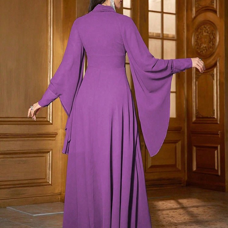 Back view of fitted princess-seam bodice and wide cape sleeves on tiered maxi dress