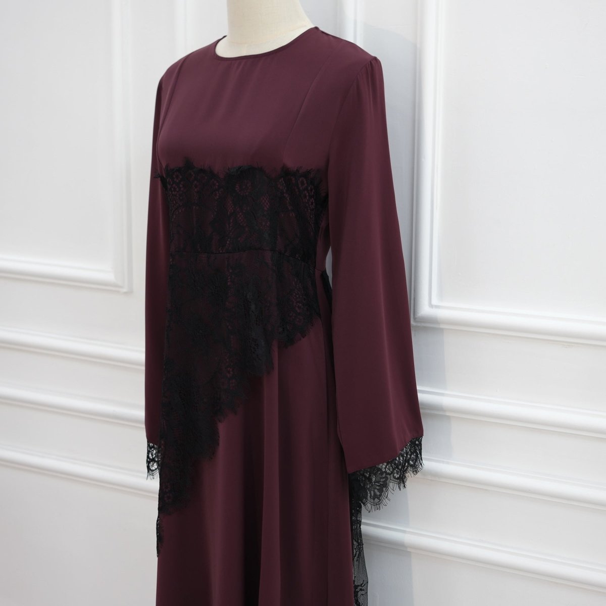 Elegant draped back of lace panel floor-length dress in motion