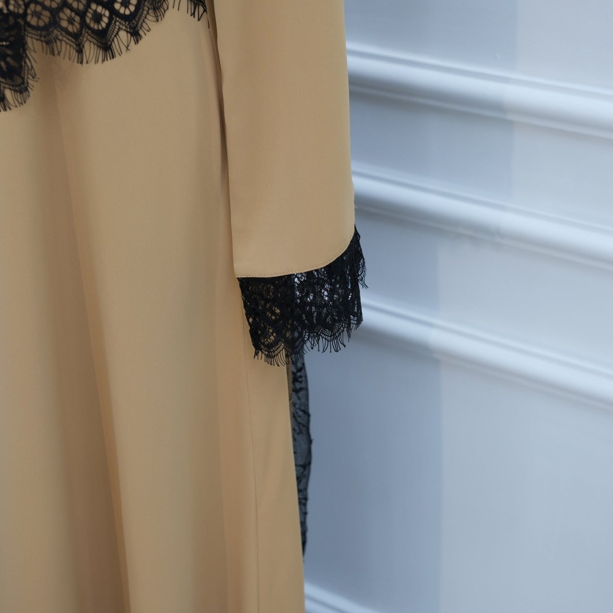 Close-up of feathered fringe lace edge at wrist cuff detail