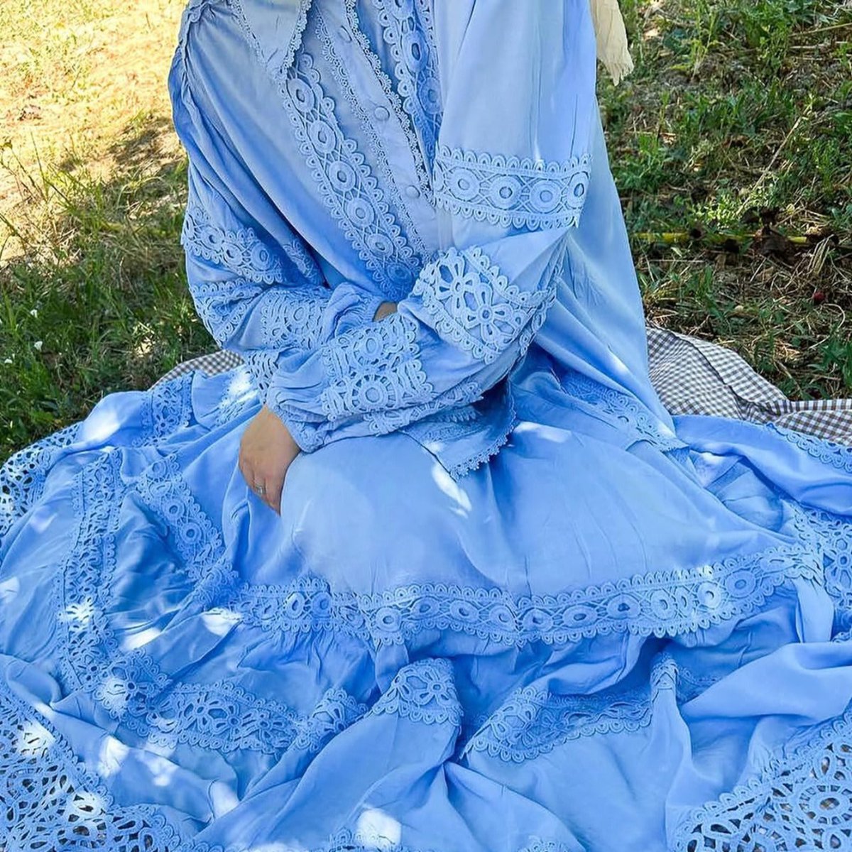 Intricate cutwork lace blouse paired with flowing tiered maxi skirt