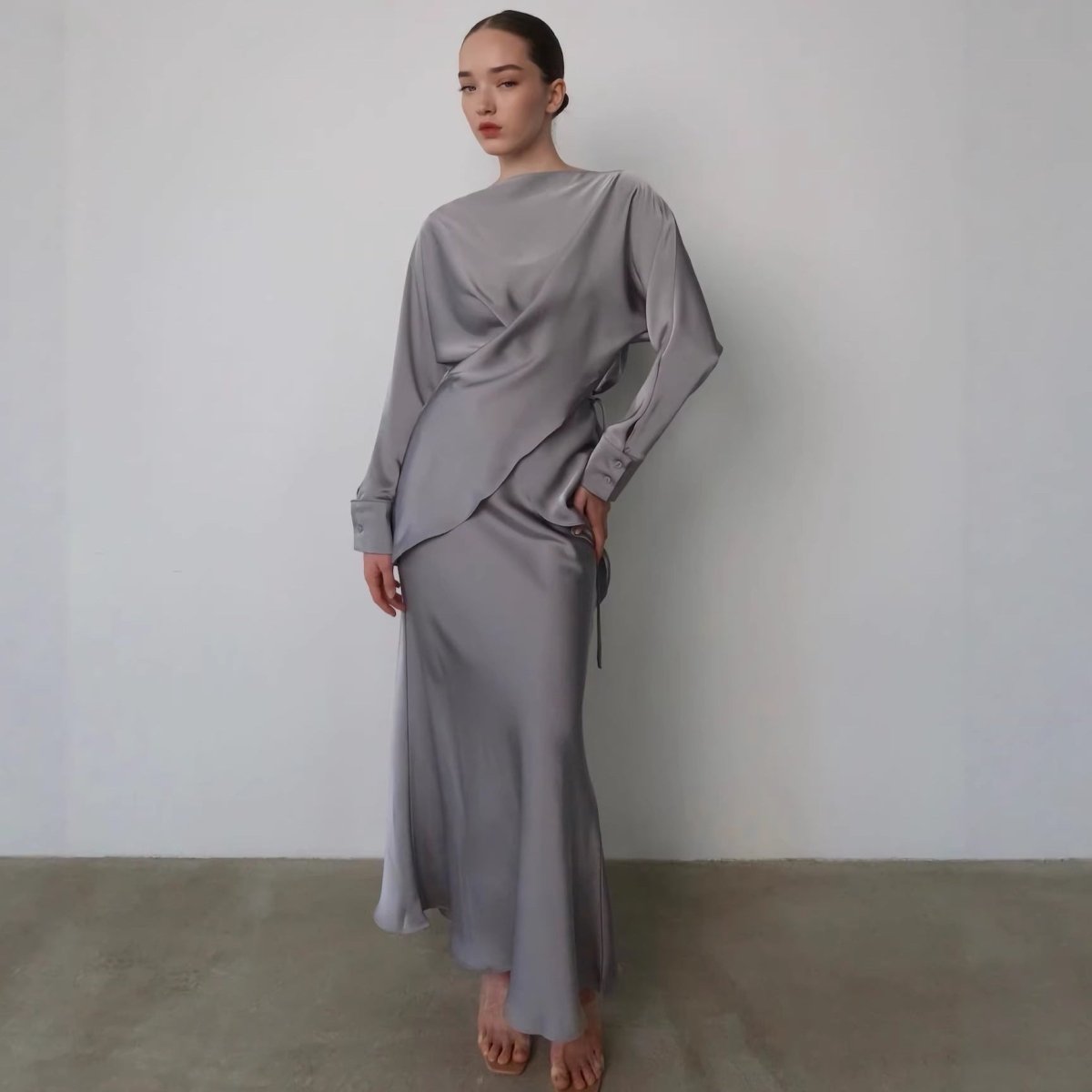 Powder blue satin wrap top with asymmetric draped peplum overlay