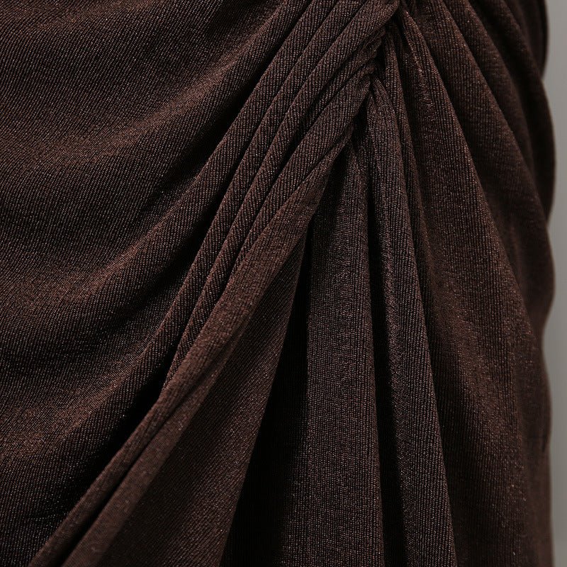 Textured fabric detail of long sleeve formal abaya dress under studio lighting