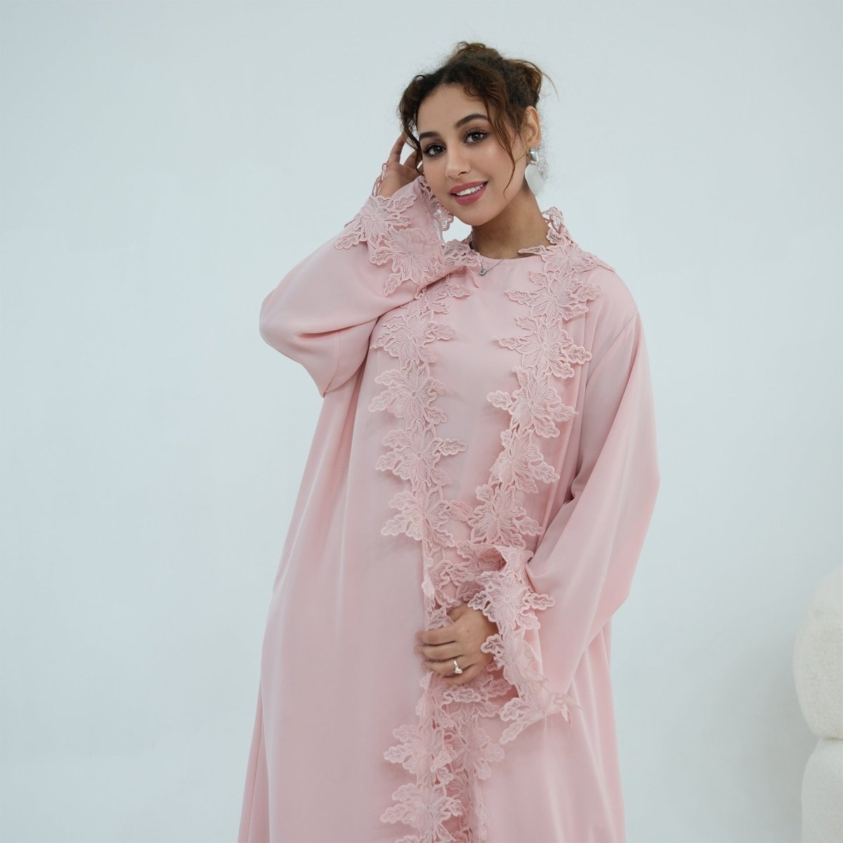 Side profile of relaxed batwing open abaya silhouette