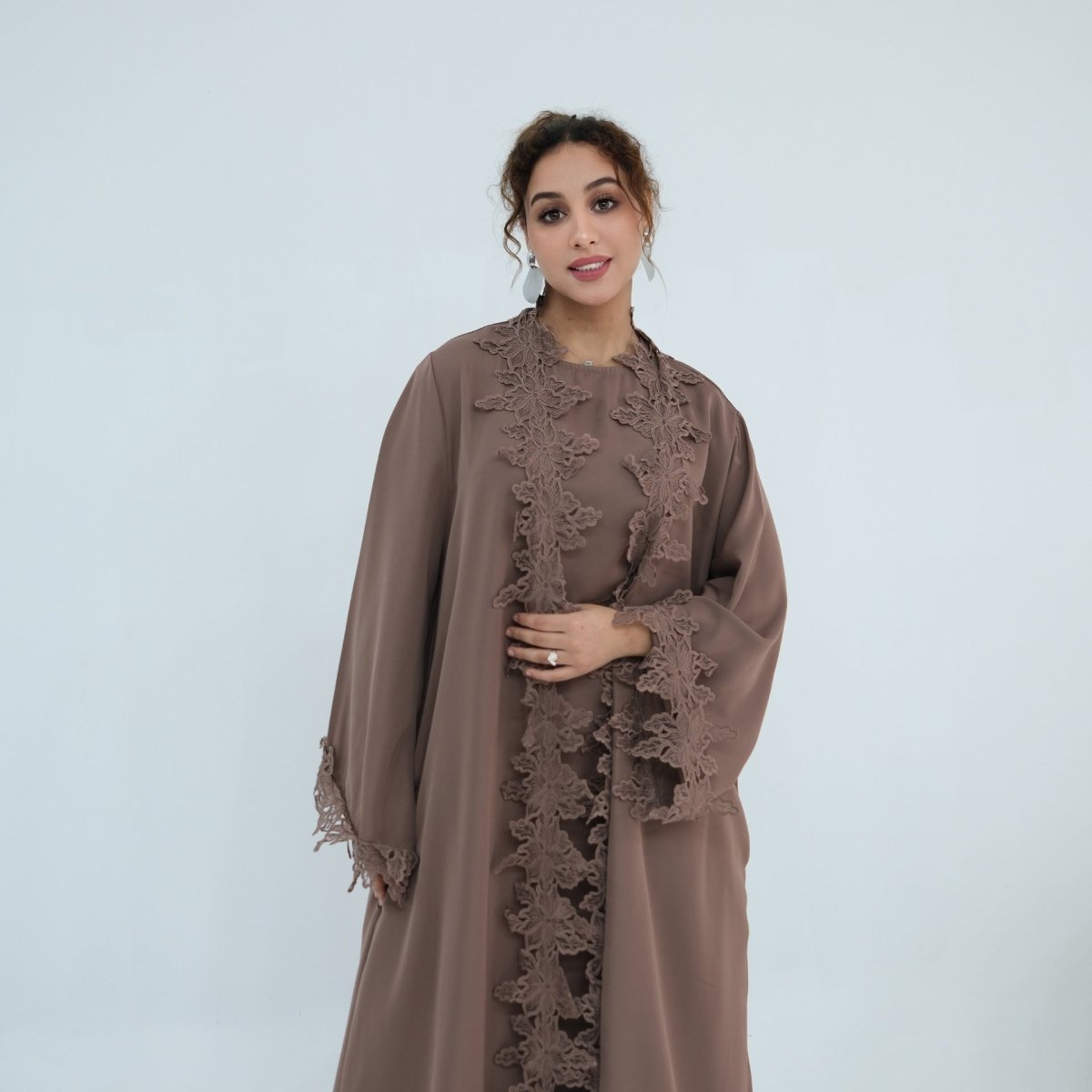 Flowing hem of floral lace open abaya