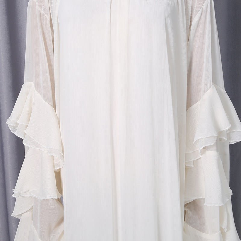 Asymmetric high-low hemline detail with ruffle trim on white dress