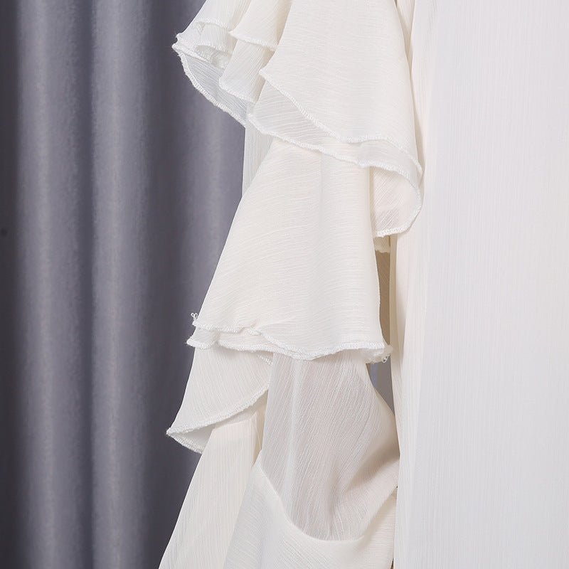 Full-length side view of flowing A-line silhouette in white chiffon