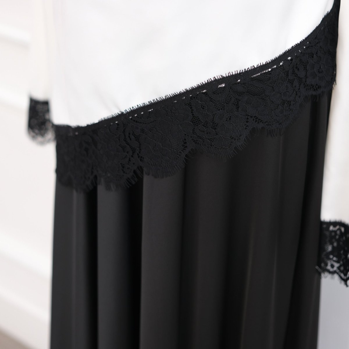 Close-up of diagonal asymmetric lace back panel detail