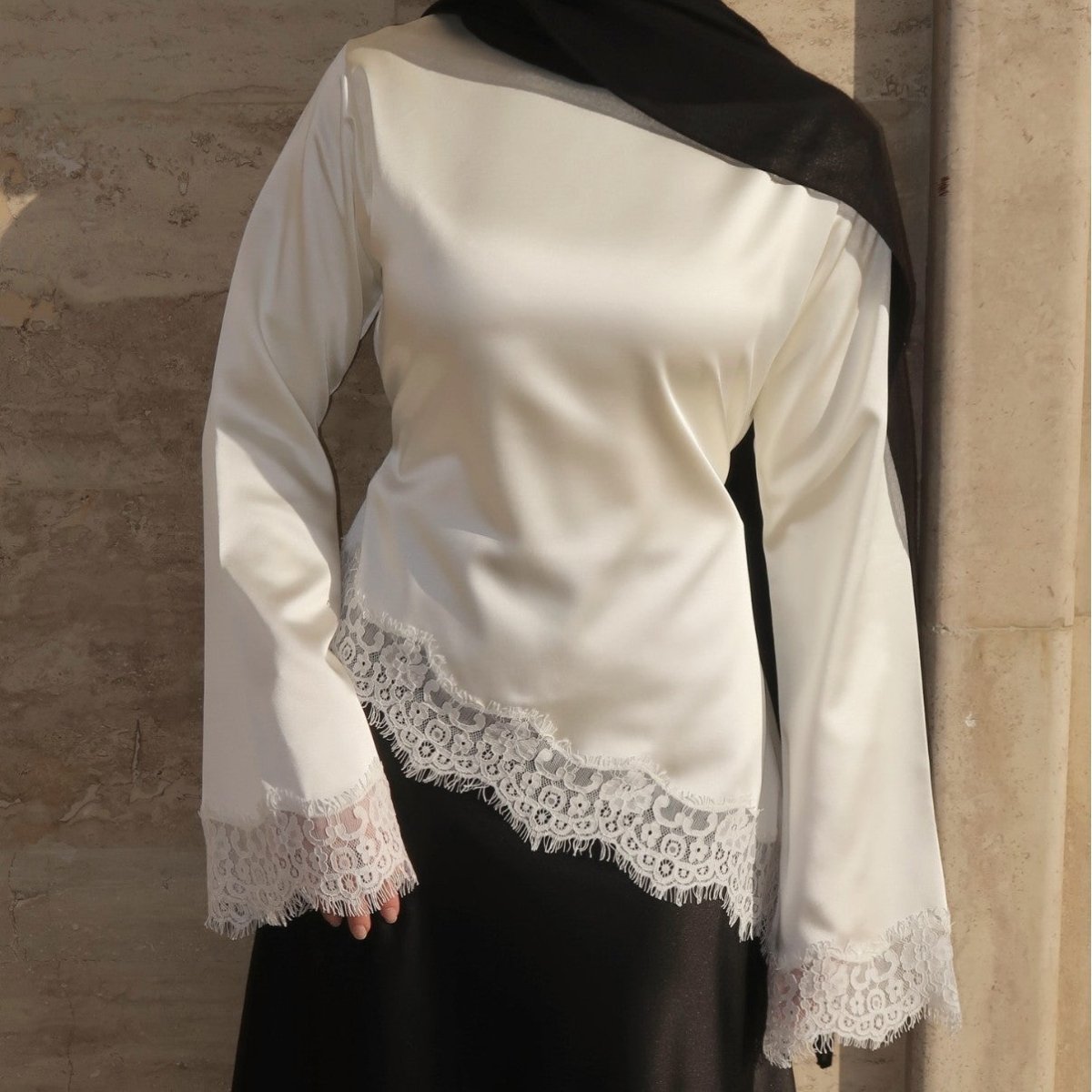 Front view of lace trim satin top showing tonal hem lace detail