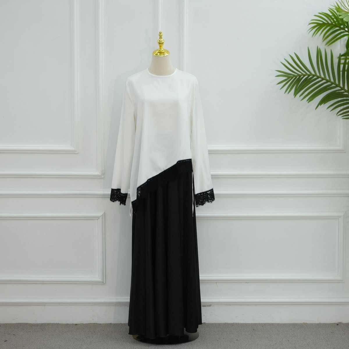 Side profile of satin top highlighting fluid drape and fitted silhouette