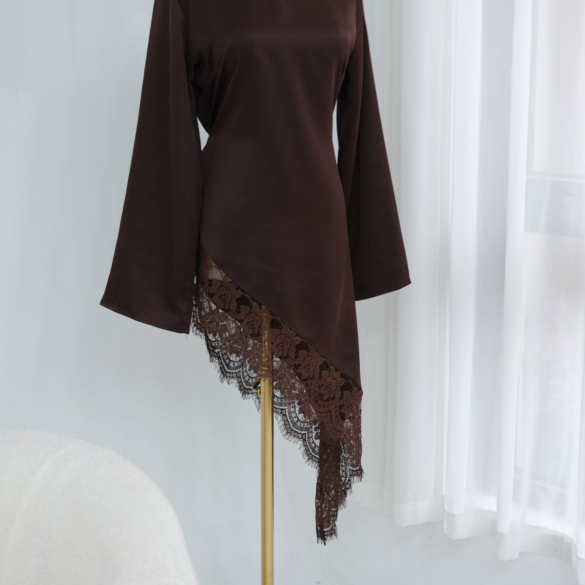 Waist ribbon cinched for a structured look on satin top