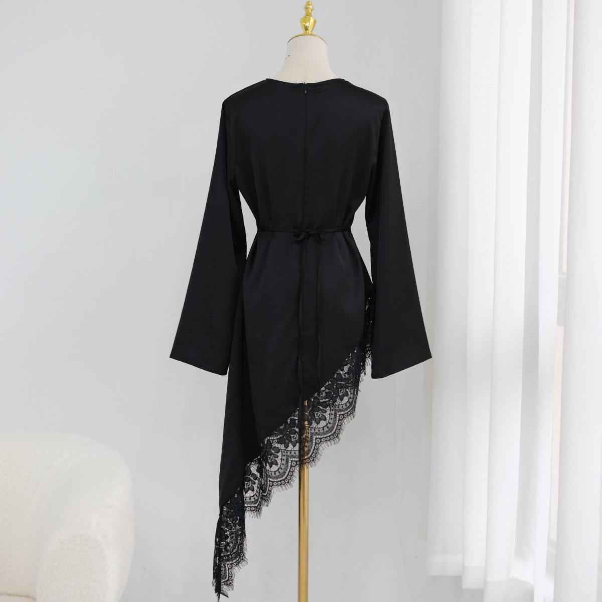 Asymmetric diagonal lace panel detail across lower back