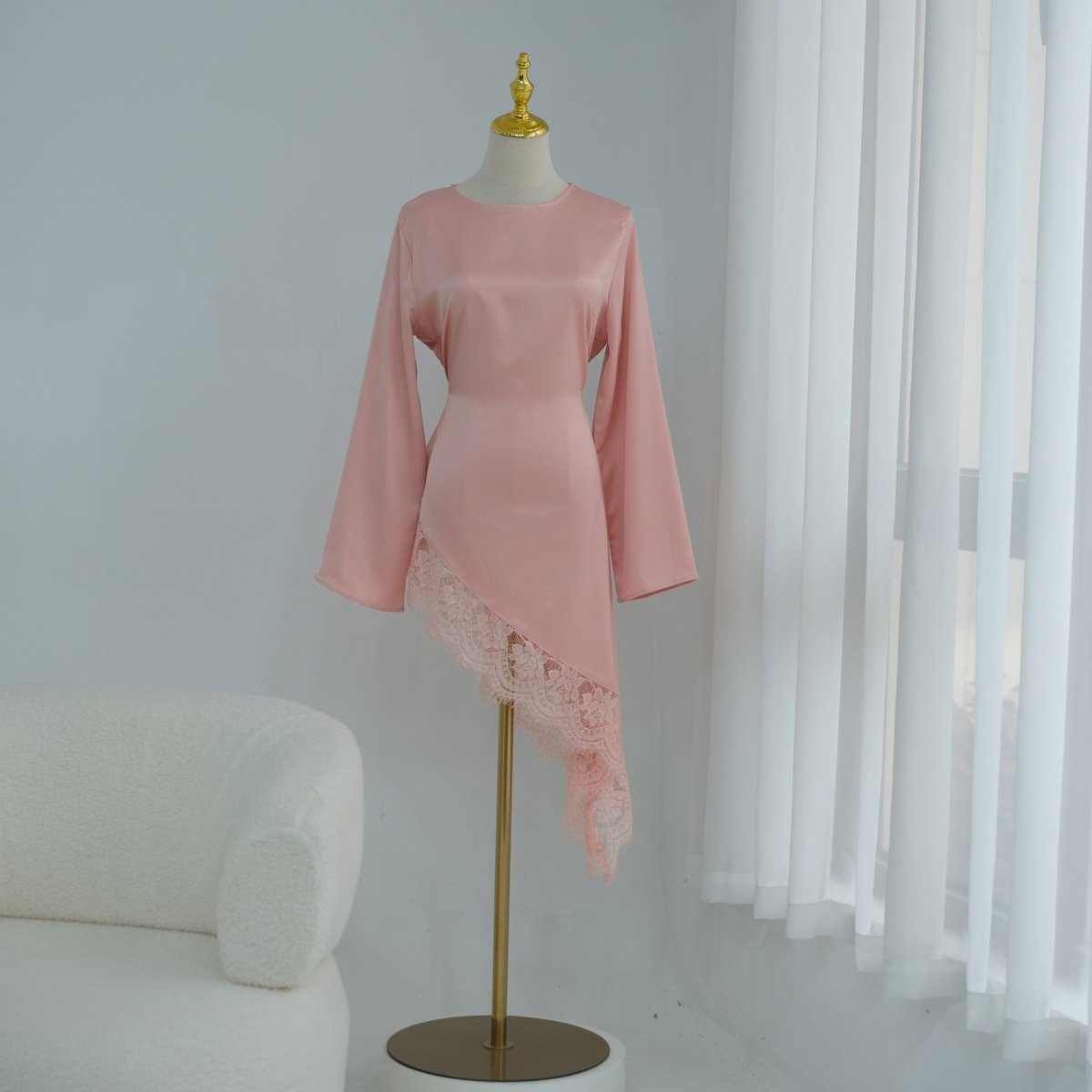 Close-up of contrast lace cuffs on wide bell sleeves