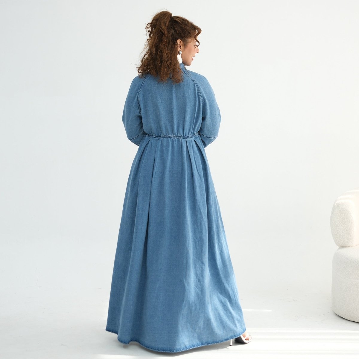 Side profile of floor-length tencel denim abaya