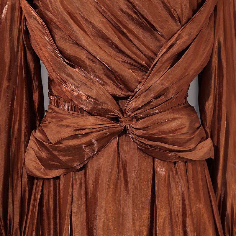 Side view of flowing A-line pleated skirt in copper bronze satin