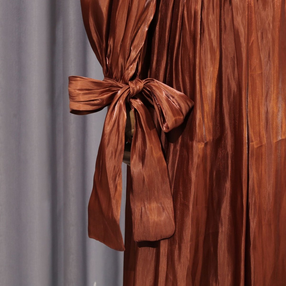 Detail shot of puff sleeves with gathered shoulders and fitted tie cuffs