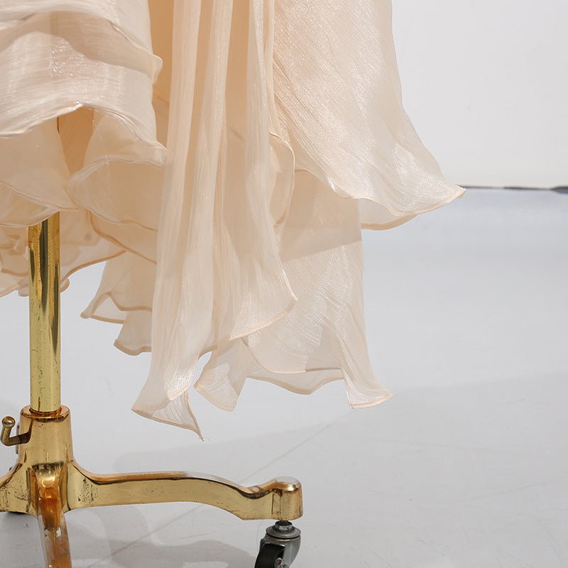 Full-length view of satin blouson occasion dress in motion showing fabric drape