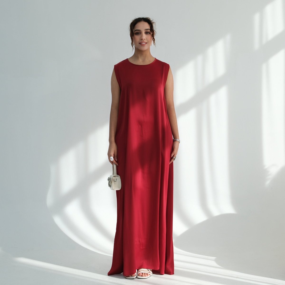 Front view of minimalist sleeveless abaya in dusty rose with A-line silhouette