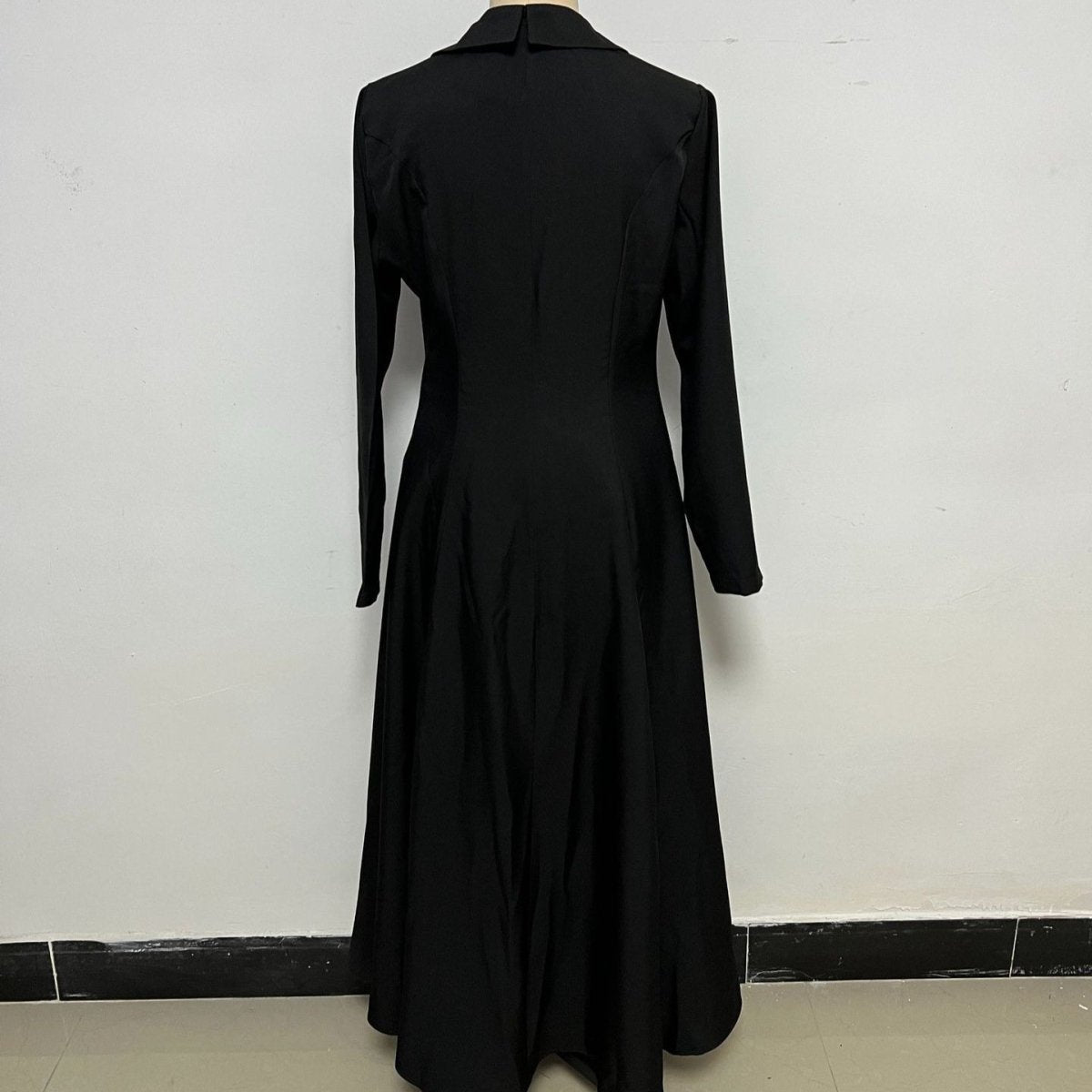 Asymmetric button closure detail along fitted waist of tailored blazer dress