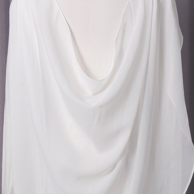 Model styling the twisted drape gown for a formal wedding event