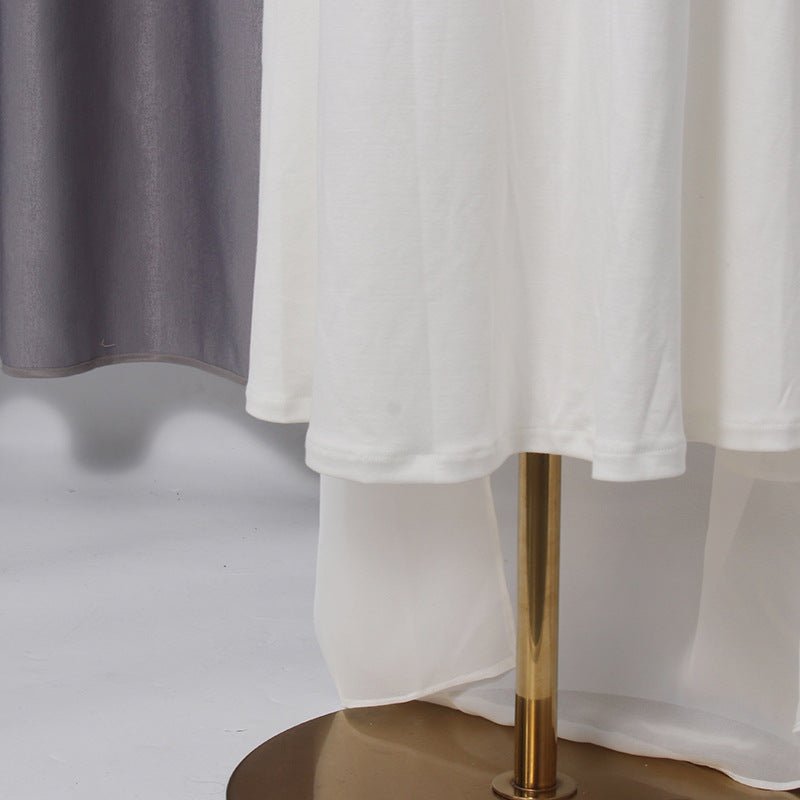 Hemline and drape movement of the white crepe chiffon maxi dress