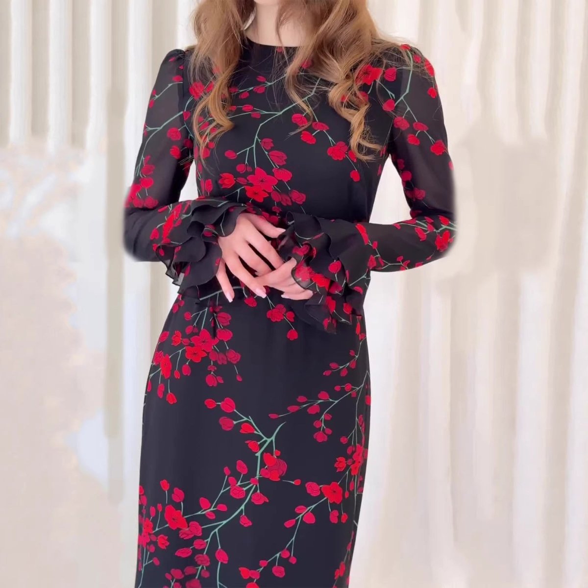 Close-up of tiered ruffle cuffs on black cherry blossom maxi dress