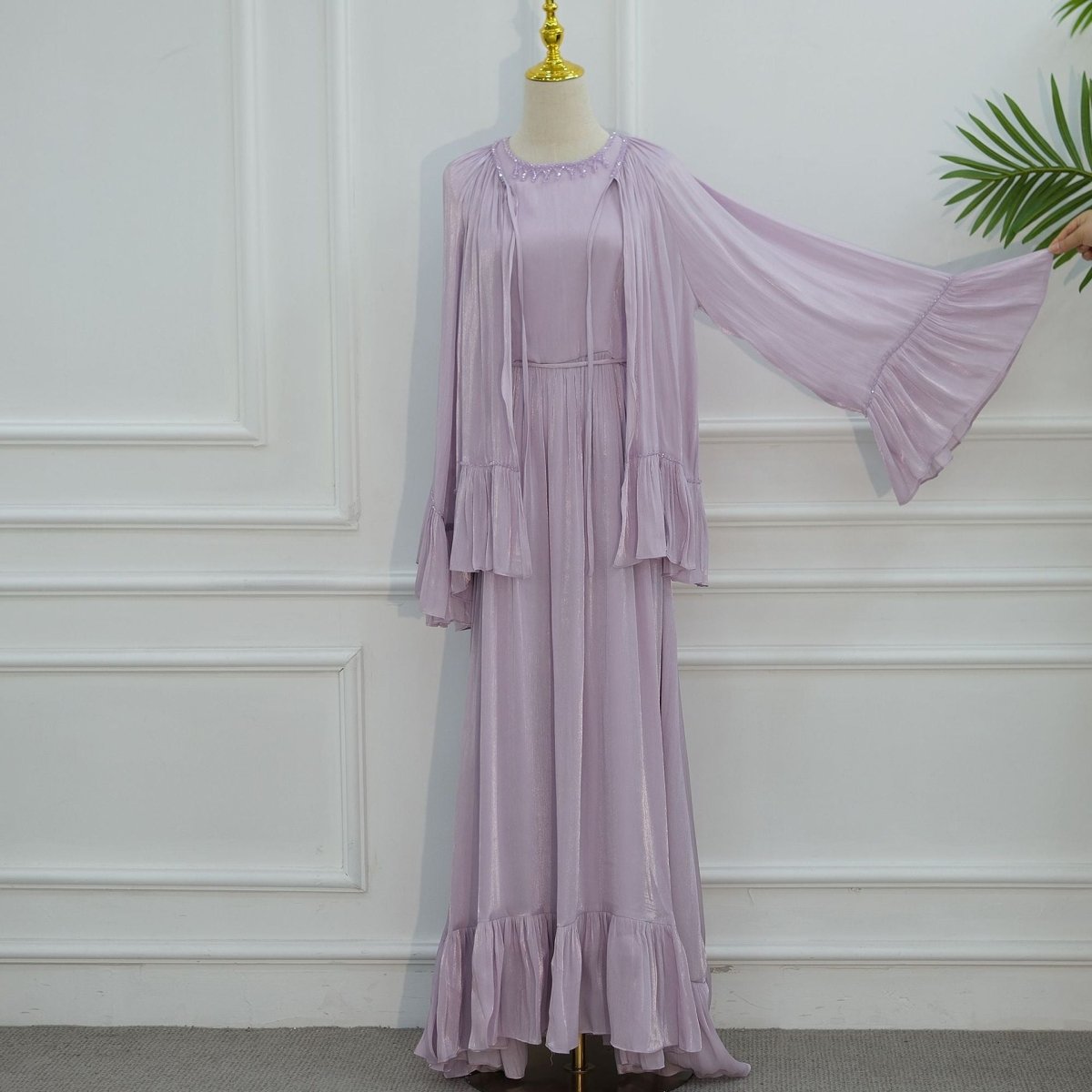 Fluid movement of floor-length pleated skirt in motion
