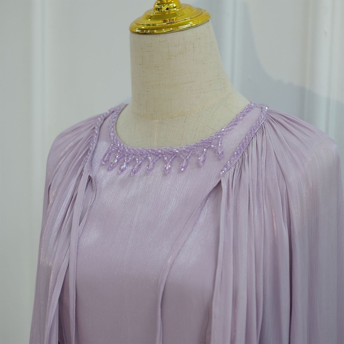 Close-up of ruffle tier cuff detail on the bell sleeve