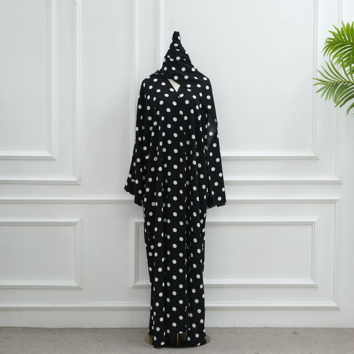 Model turning to show movement of polka dot crepe open abaya