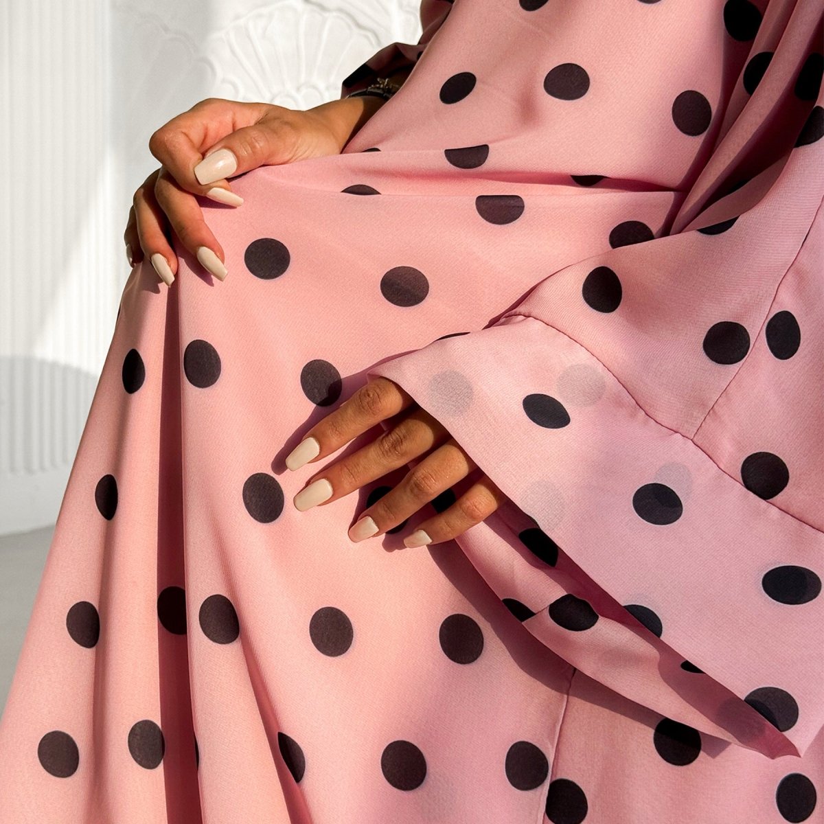 Polka dot abaya set styled for a summer garden party
