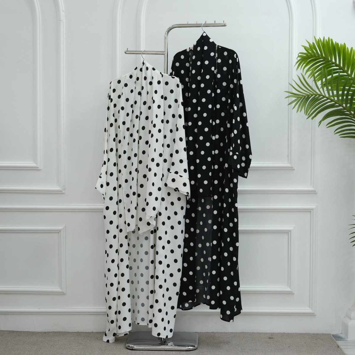 Polka dot hijab styled with matching open abaya — front close-up