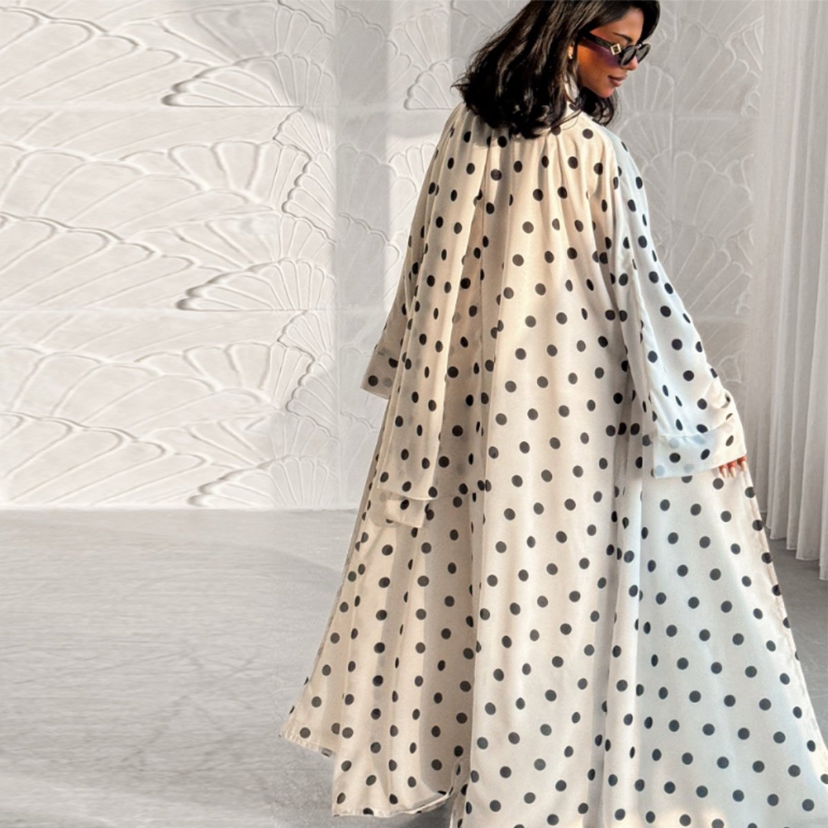 Front view of polka dot open abaya cardigan with draped V-neckline