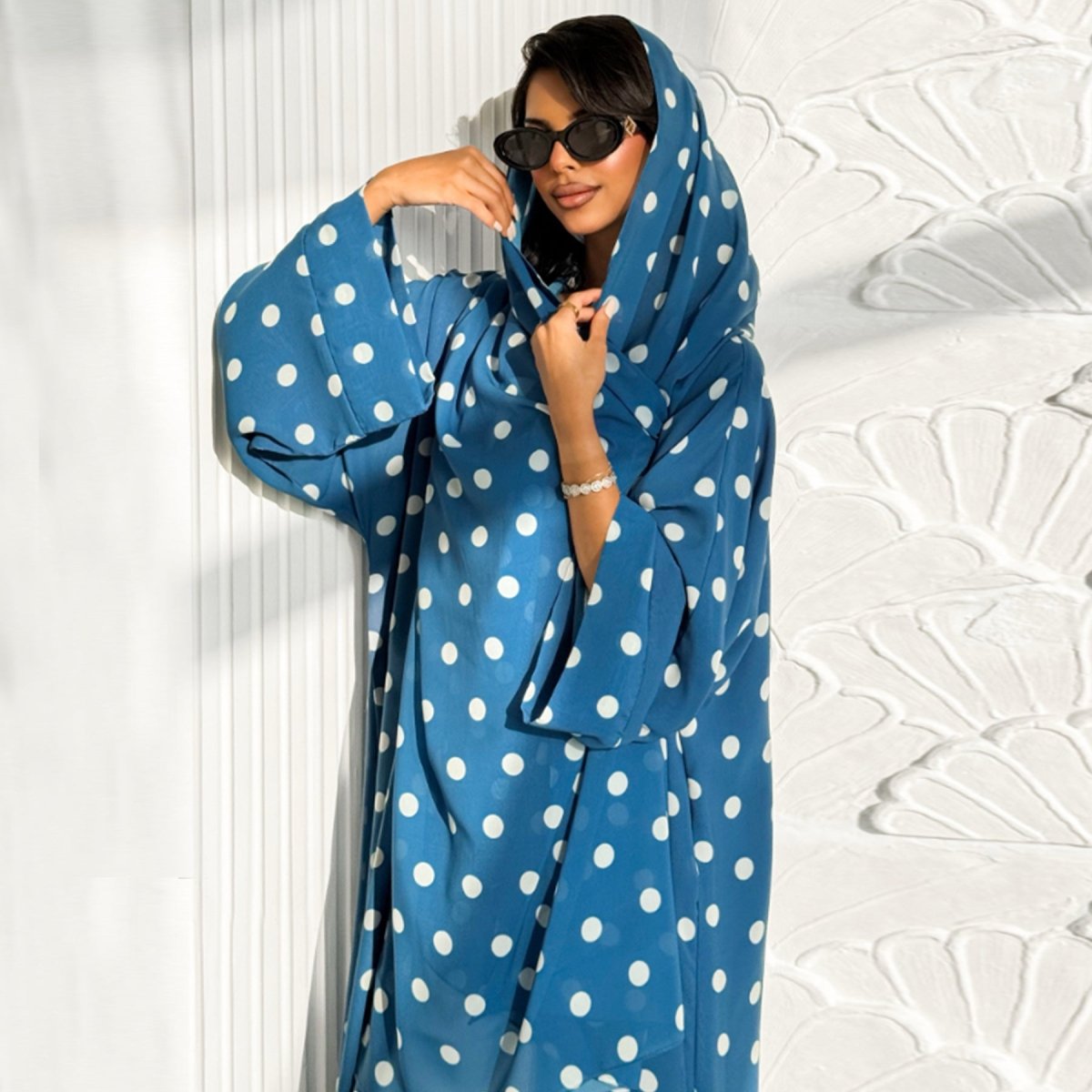 Model walking in polka dot batwing open abaya — flowing movement shot