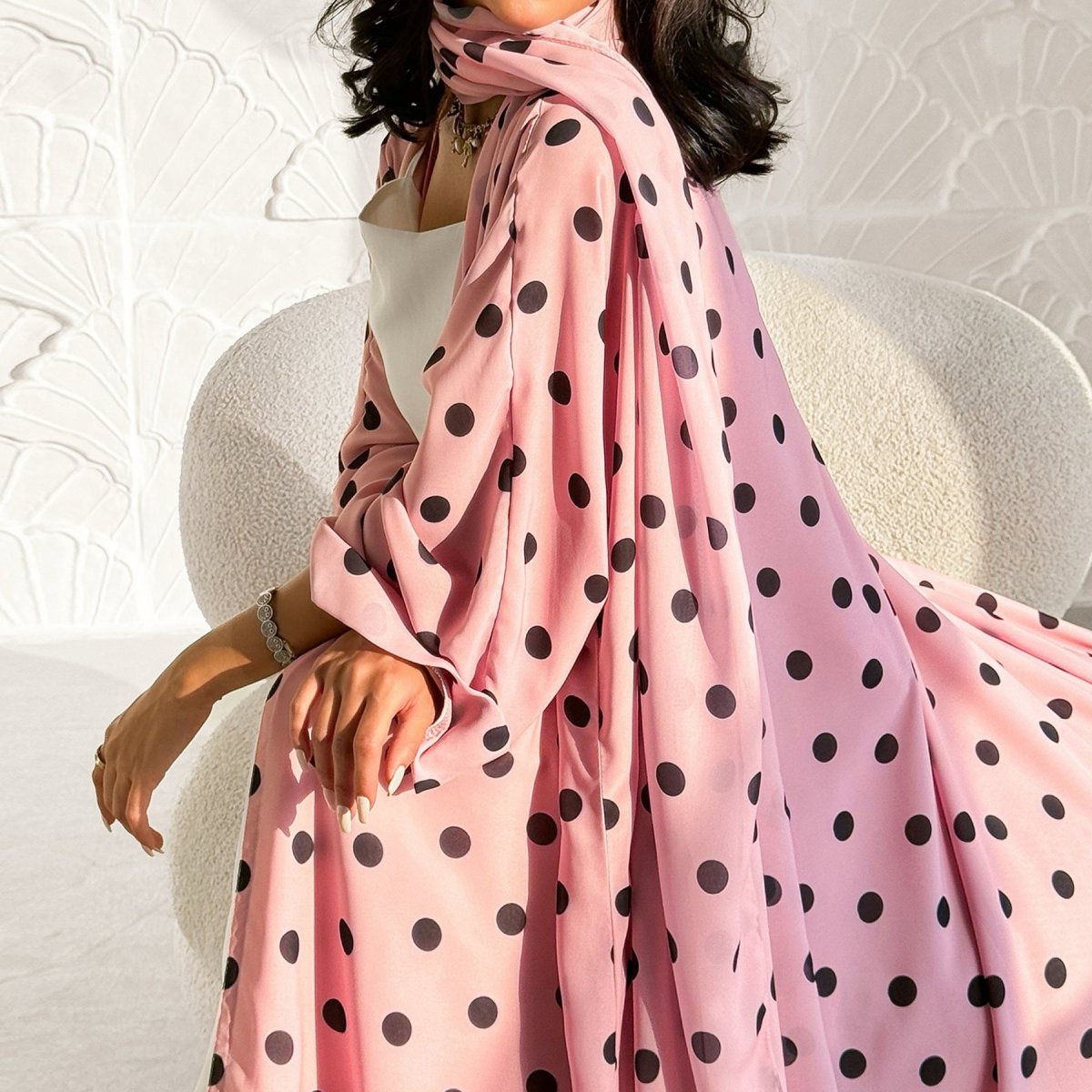 Draped V-neckline close-up on polka dot open abaya cardigan
