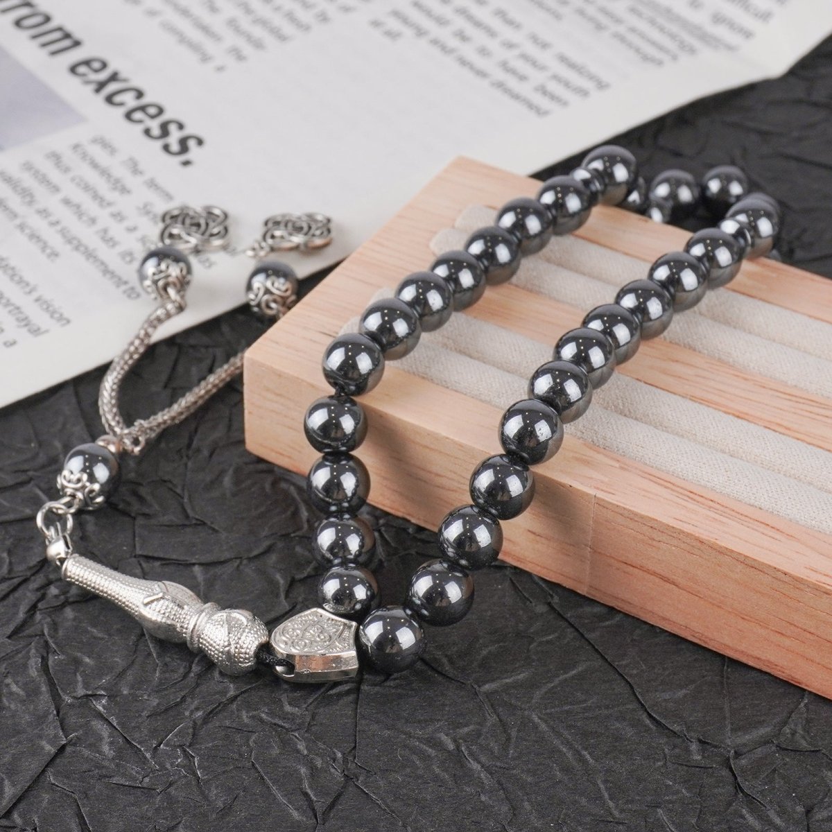 33 natural black obsidian prayer beads laid flat showing smooth volcanic glass finish