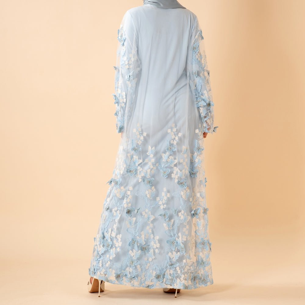 Model wearing the Butterfly Whisper abaya styled with a matching self-tie belt