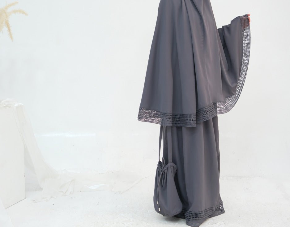 Four-piece prayer set laid flat showing khimar, skirt, prayer mat and storage bag