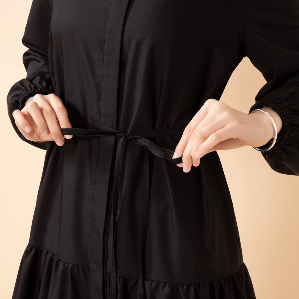 Full outfit flat lay of A-line trench shirt abaya and belt