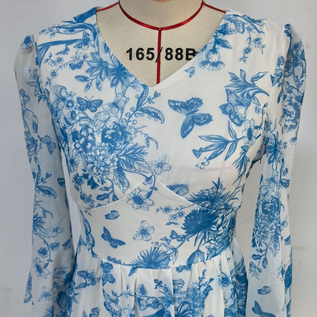 Blue botanical maxi dress with chinoiserie print and elegant silhouette