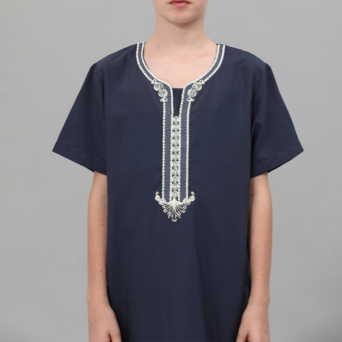 V-neckline detail of boys embroidered thobe with contrast threadwork