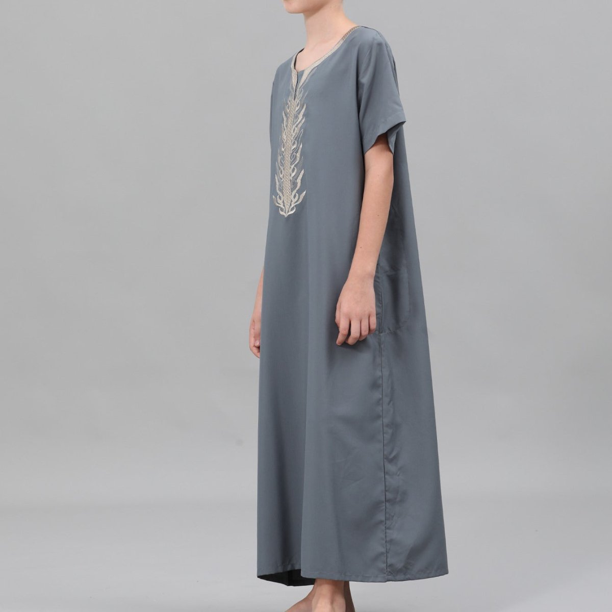 Boys' thobe with gold embroidery on cream fabric, close-up detail